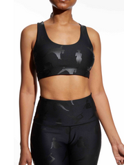 Photo of model in Black-Owned Lukafit activewear. Model is wearing squat-proof black leggings and matching black sports bra.