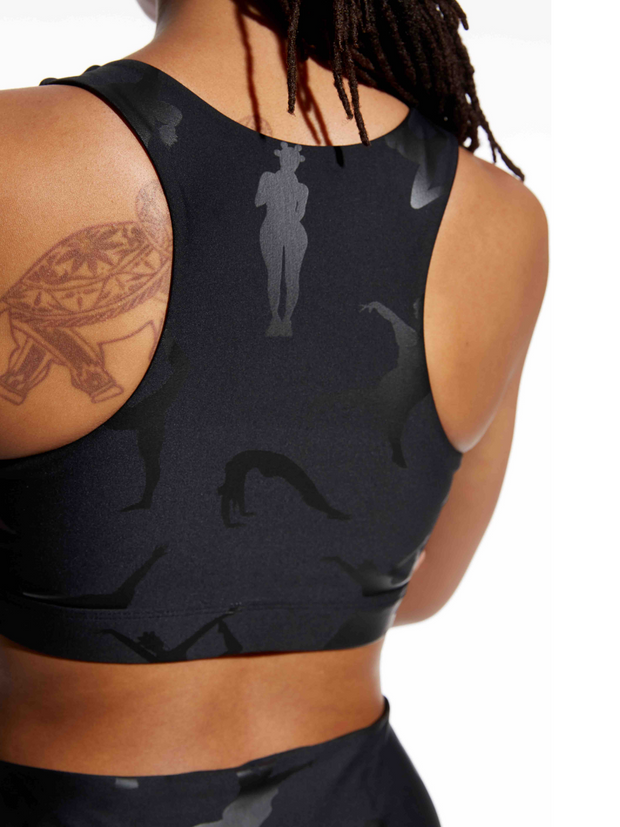 Close up photo of a model in Black-Owned Lukafit activewear. Model is wearing a black sports bra.